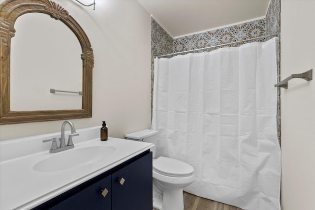 bathroom featuring vanity, wood-type flooring, toilet, and walk in shower