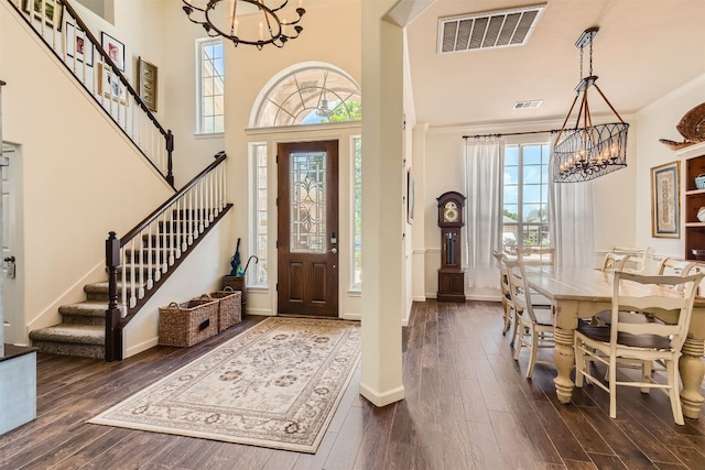 foyer featuring dark hardwood / wood-style flooring, plenty of natural light, and an inviting chandelier