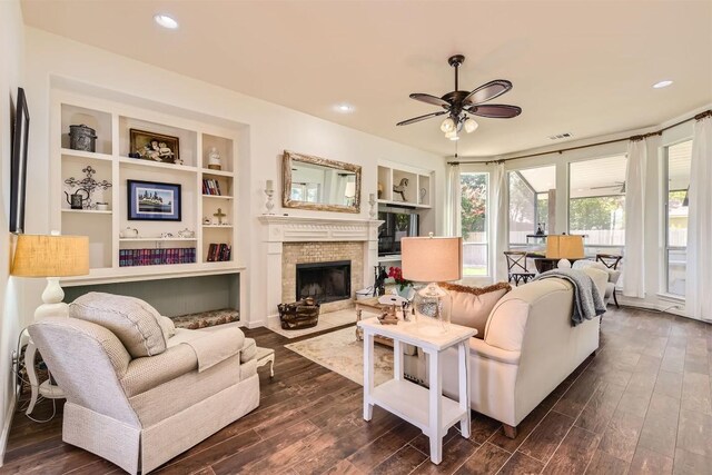 134 Fairwood Dr, Georgetown, TX 78628 - living area featuring ceiling fan, dark wood-type flooring, a brick fireplace, and recessed lighting