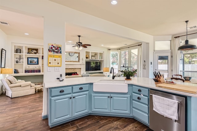 kitchen featuring dark hardwood / wood-style floors, blue cabinets, sink, and hanging light fixtures