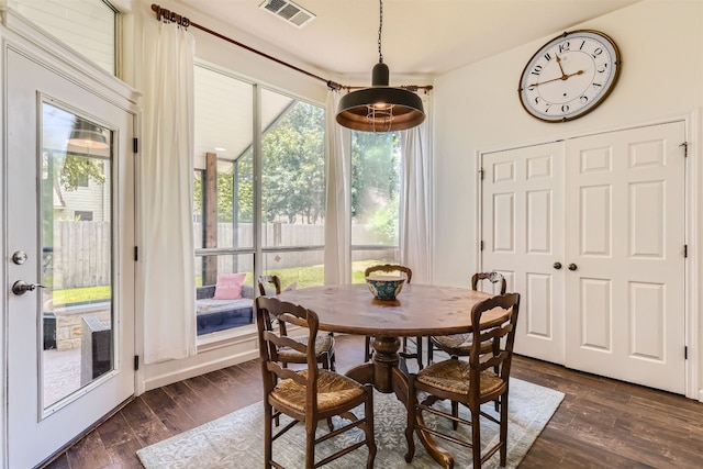 dining area featuring dark wood-type flooring