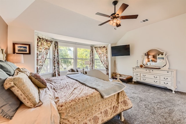 carpeted bedroom with ceiling fan and vaulted ceiling