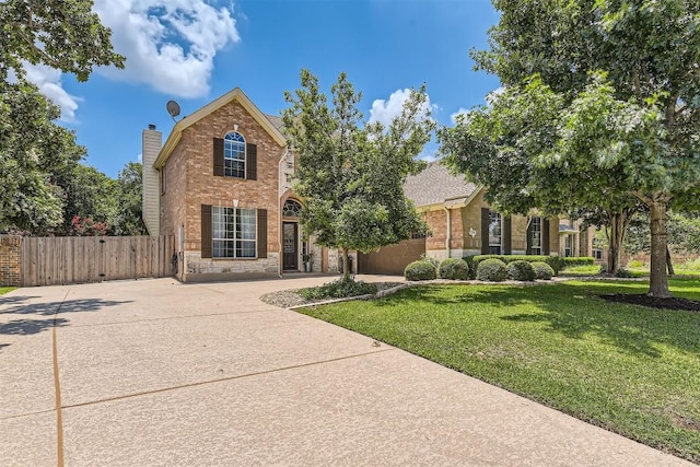 134 Fairwood Dr, Georgetown, TX 78628 - traditional-style house featuring brick siding, stone siding, a gate, and concrete driveway