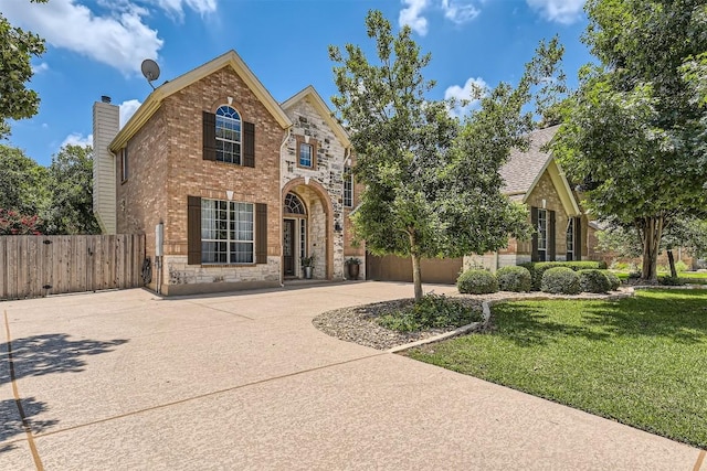 134 Fairwood Dr, Georgetown, TX 78628 - traditional home with stone siding, brick siding, and a gate