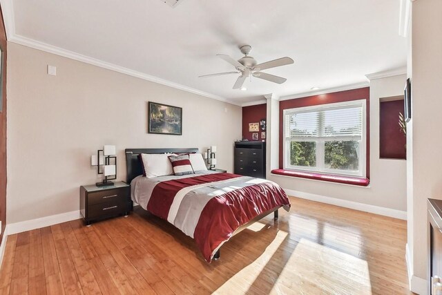 bedroom with crown molding, light wood-type flooring, and ceiling fan