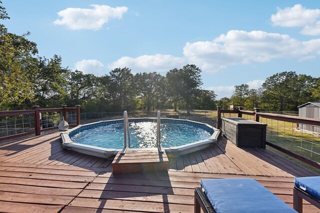 view of swimming pool featuring a deck