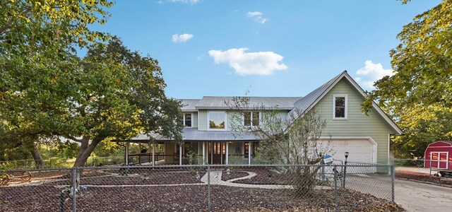 view of front of property with a porch and a garage