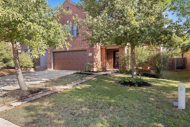 view of front of home with a front yard and a garage