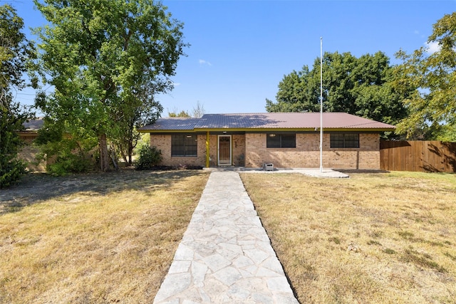 ranch-style home with a front lawn