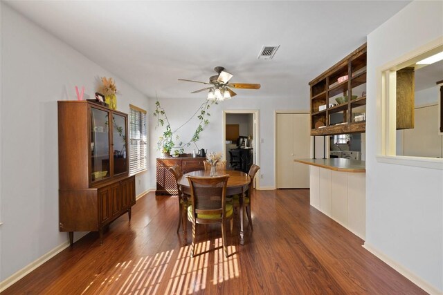 dining room featuring ceiling fan and dark hardwood / wood-style flooring