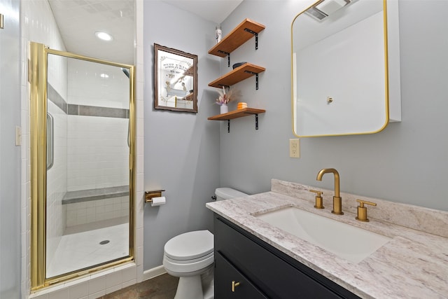 bathroom featuring an enclosed shower, vanity, and toilet