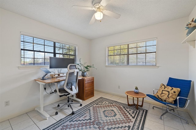 office space featuring ceiling fan, light tile patterned floors, and a textured ceiling