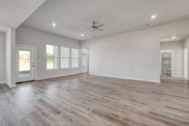 empty room with light hardwood / wood-style floors and ceiling fan