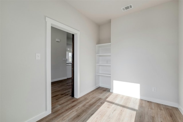 spare room featuring light wood-type flooring