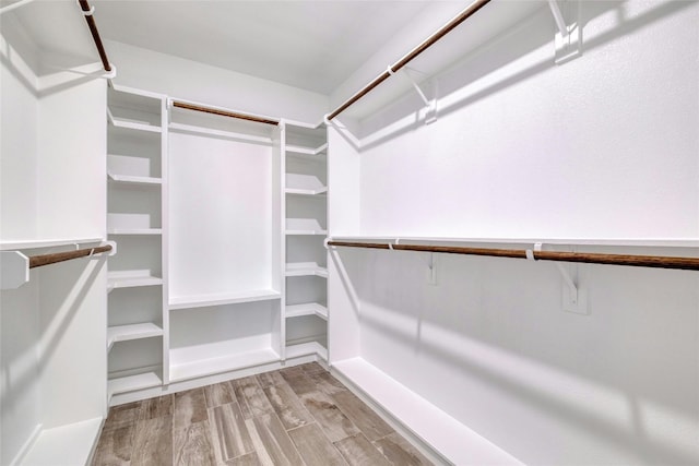 walk in closet featuring light hardwood / wood-style flooring