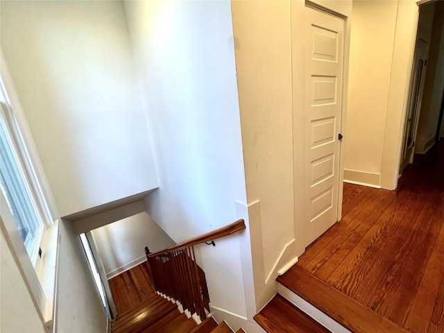 stairway with wood finished floors