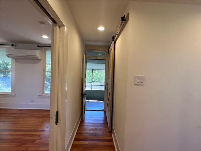 314 Pershing Ave, San Antonio, TX 78209 - hallway with dark wood finished floors, recessed lighting, a barn door, a wall mounted AC, and baseboards