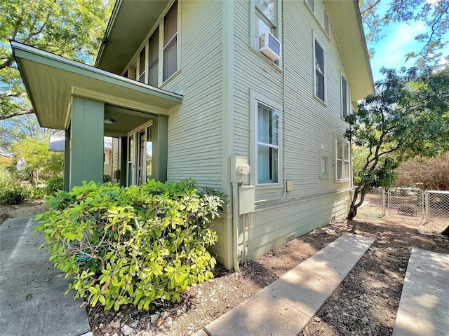 view of side of home featuring fence