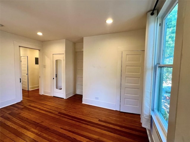 unfurnished bedroom featuring recessed lighting, dark wood finished floors, and baseboards