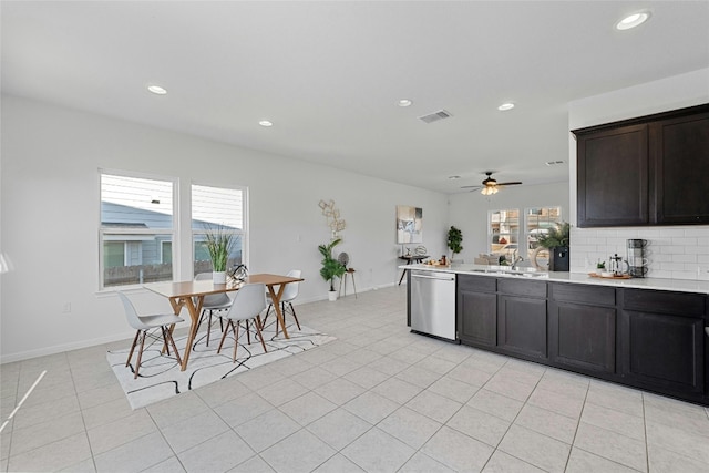 kitchen featuring decorative backsplash, ceiling fan, light tile patterned floors, stainless steel dishwasher, and sink