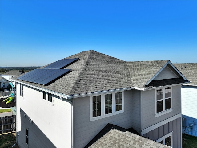 view of property exterior with solar panels