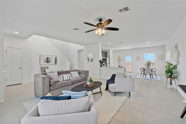 living room with ceiling fan and light tile patterned floors