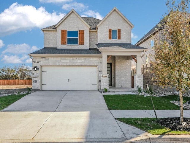 craftsman house featuring a garage and a front lawn