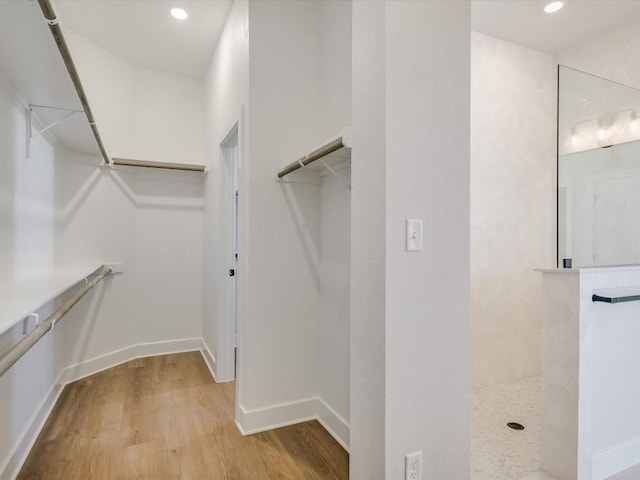 walk in closet with light wood-type flooring