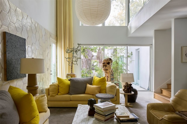 living room with a healthy amount of sunlight and a high ceiling