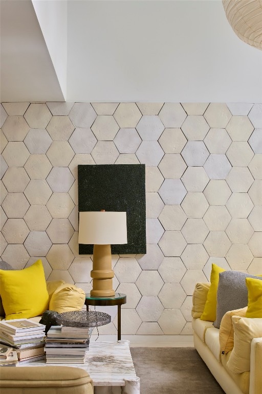 unfurnished living room featuring tile walls