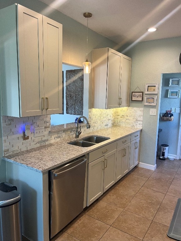 kitchen with stainless steel dishwasher, sink, decorative backsplash, and pendant lighting