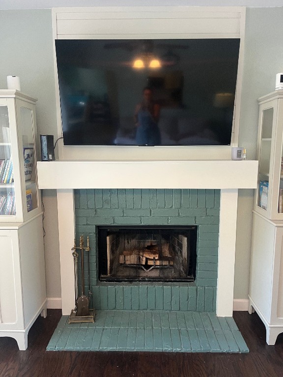 interior details with hardwood / wood-style floors and a fireplace