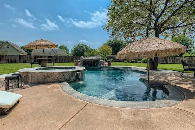 view of pool featuring a patio area, pool water feature, an in ground hot tub, and a lawn