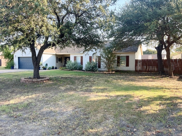 ranch-style home featuring a front yard and a garage