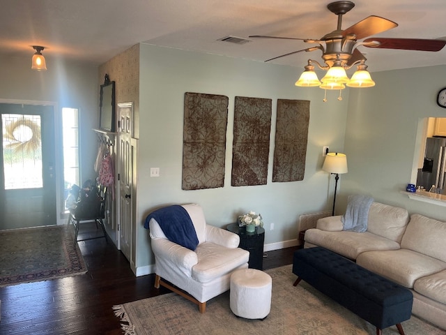 living room with dark wood-type flooring and ceiling fan