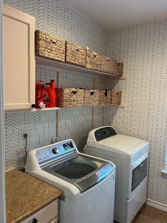 washroom with separate washer and dryer and tile patterned flooring