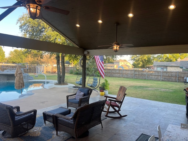 view of patio with a fenced in pool and ceiling fan