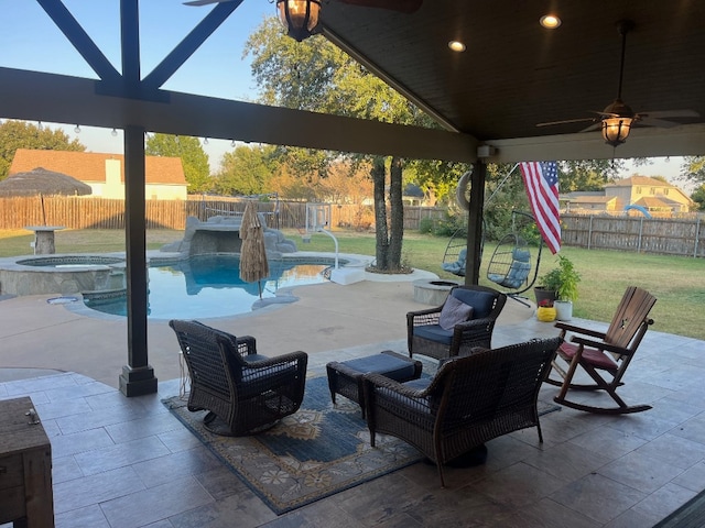 view of patio / terrace with a pool with hot tub and ceiling fan