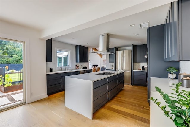 2900 Windsor Rd, Austin, TX 78703 - kitchen with island range hood, freestanding refrigerator, a sink, a kitchen island, and light countertops