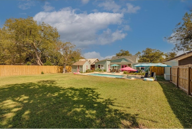 view of yard featuring a patio and a fenced in pool