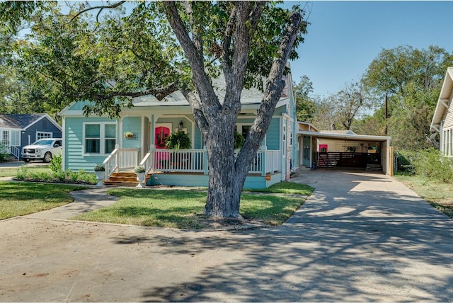 view of front of home featuring covered porch, a front yard, and a carport