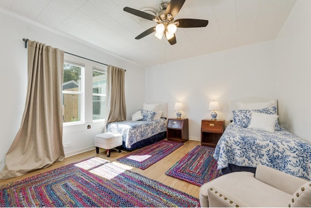 bedroom with wood-type flooring and ceiling fan