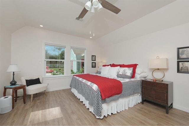 bedroom with lofted ceiling, light hardwood / wood-style floors, and ceiling fan