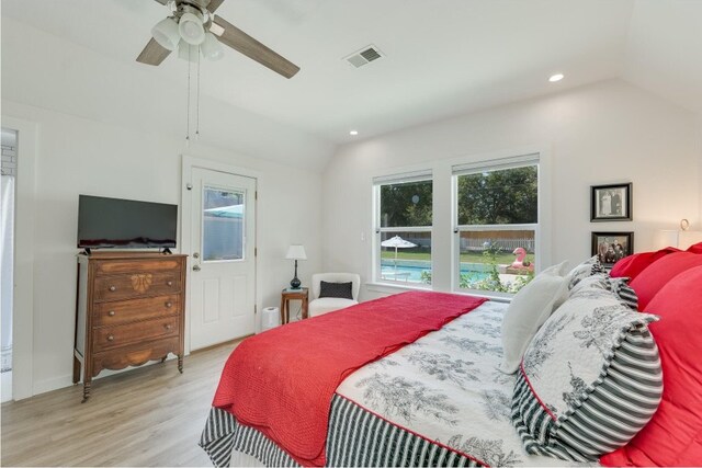 bedroom featuring ceiling fan, light wood-type flooring, and vaulted ceiling