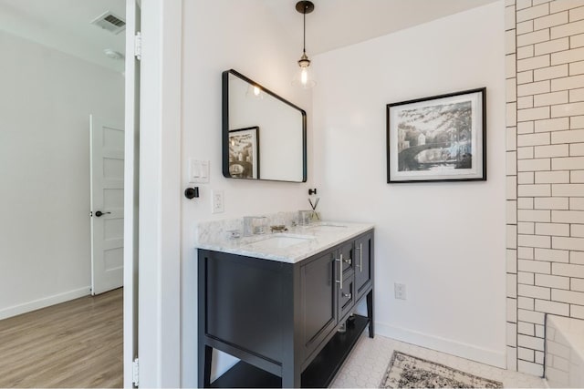 bathroom featuring vanity and hardwood / wood-style floors