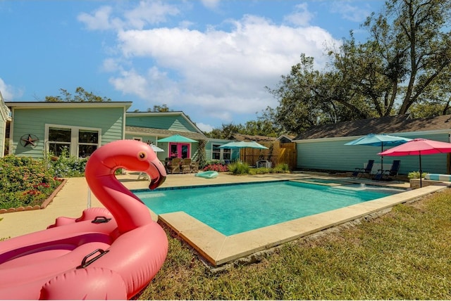 view of swimming pool featuring a lawn and a playground