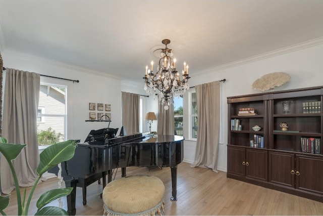 misc room with light hardwood / wood-style flooring, ornamental molding, and a chandelier