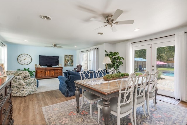 dining space featuring french doors, light wood-type flooring, and ceiling fan