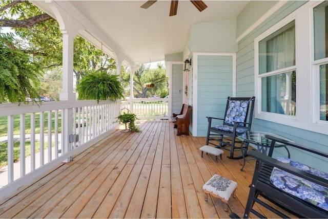 wooden deck with a porch and ceiling fan