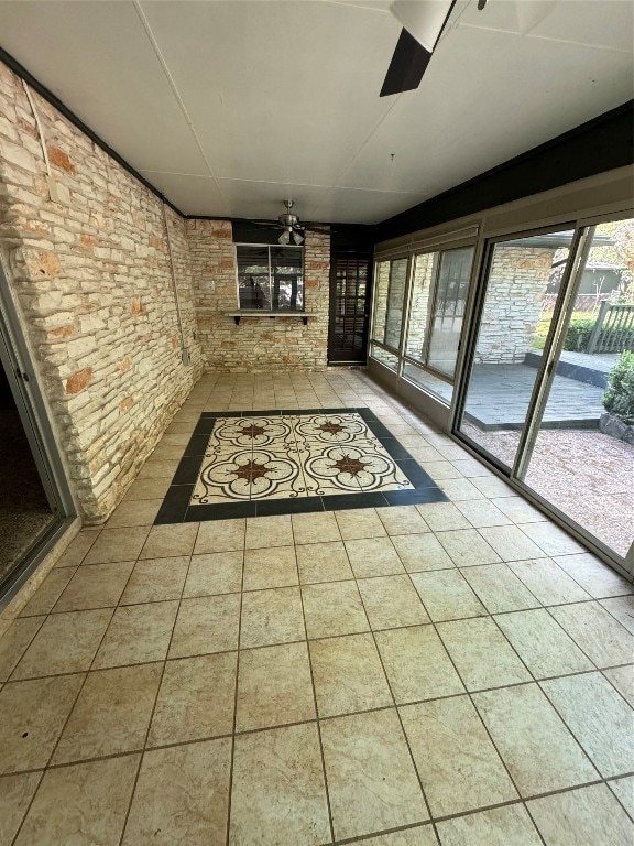 hallway featuring brick wall and tile patterned floors